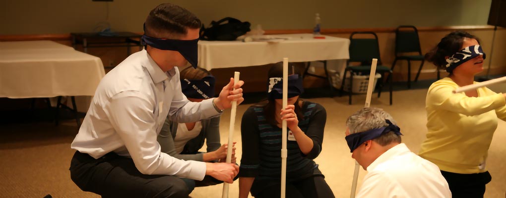 Blindfolded students attempt to construct object in teams