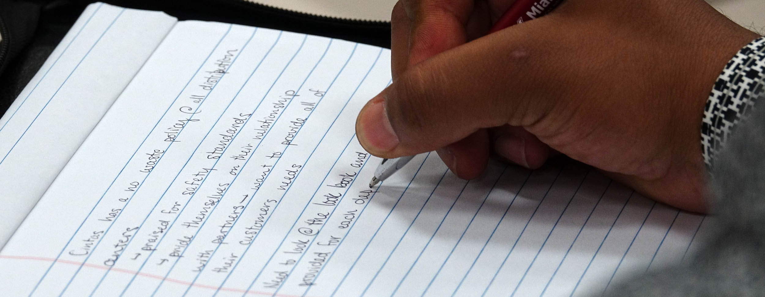 Hand writing on notebook at CINTAS