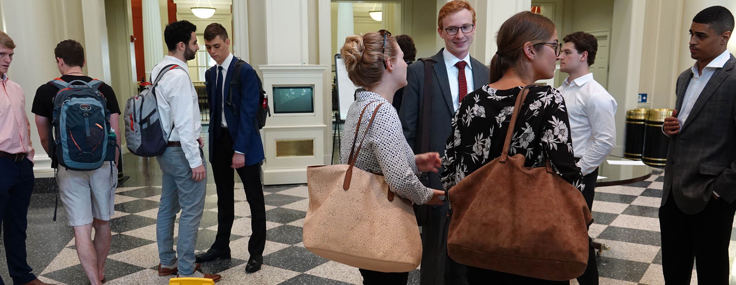 Students in lobby of Farmer School after presentations to Cintas