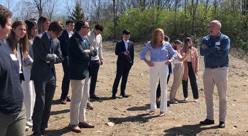 Students and executives examine a real estate location near Columbus.