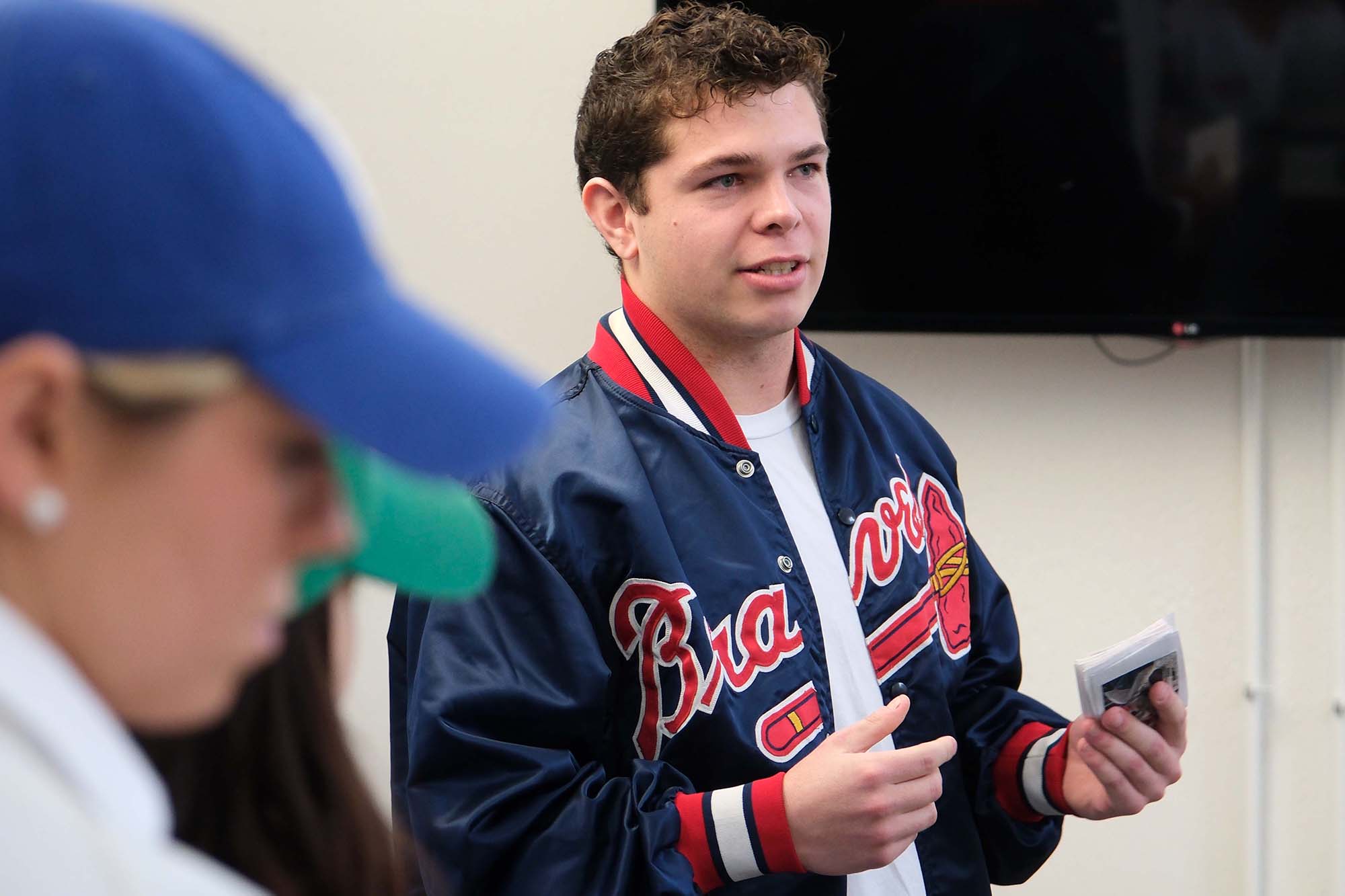 Student making presentation in Braves jacket