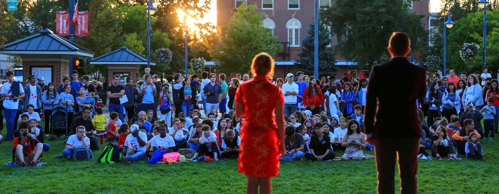 hosts from Chinese Festival speaking to an audience in uptown Oxford