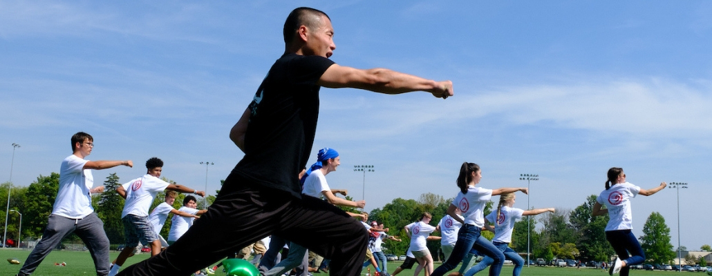 Martial arts instructor showing students from local schools how to practice the art