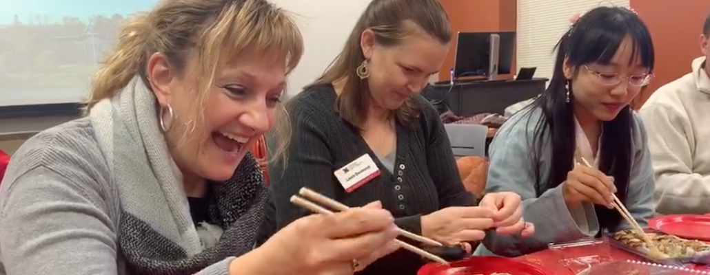 woman learning how to use chopsticks