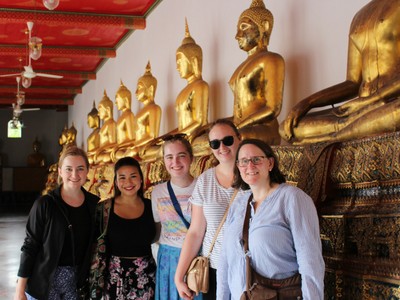 Miami students with Karla in front of statue in Bangkok