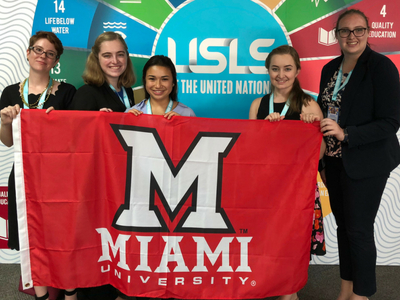 students holding Miami flag