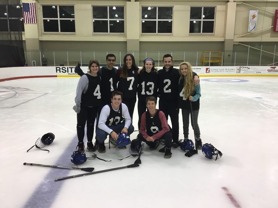 Pranshu and his broomball team post after winning the championship game.