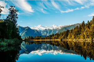 a beautiful image of a lake with a reflection of mountains in the water