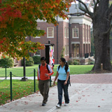 Two students walking on an autumn day