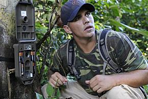 Matt Hallett sets up one of the remotely triggered cameras for his creature population study.