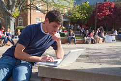 Student studying on his laptop