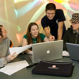 Students gathered around a screen