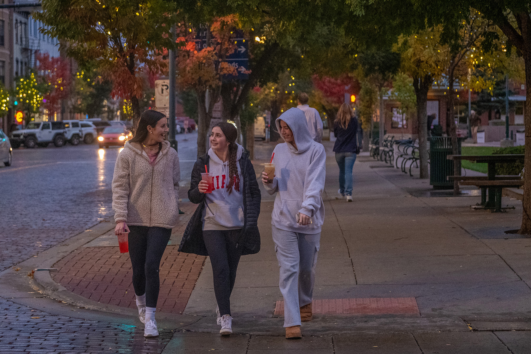 Students walk uptown at night.
