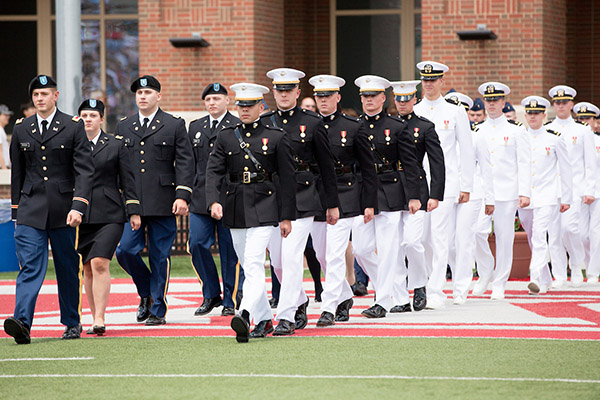 ROTC students march onto the field at commencement.