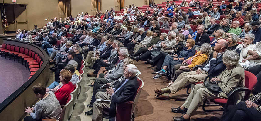 Audience members sitting at their seats during an event in Parrish Auditorium.