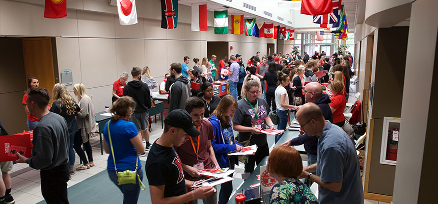 The Harry T. Wilks Conference Center main hallway with student talking to different booths during a SOAR event.