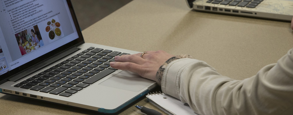 A students fingers typing on her keyboard.