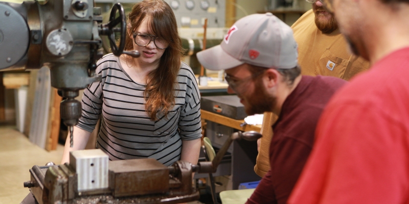 A group of 3 students working in the Manufacturing lab
