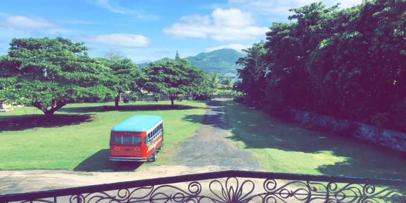 American Samoa view with bus in foreground and mountains in background