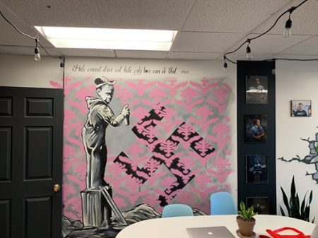 A wall with artwork on it at The Fringe Coffee House