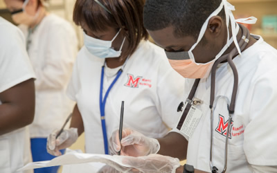 Nursing students in checking charts.