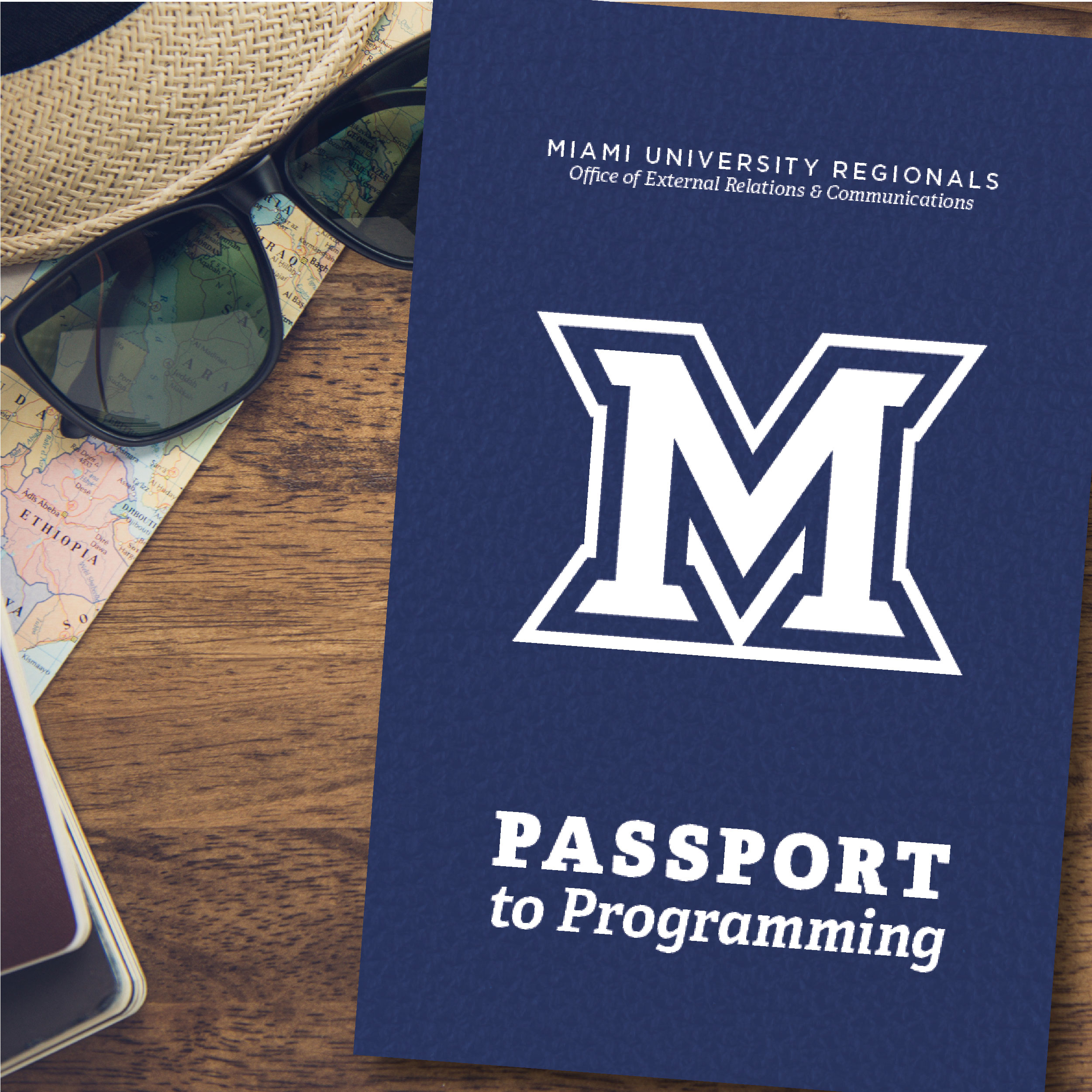 Join our event loyalty program! #FlyMiamiOH Sunglasses and a passport on a wooden table.