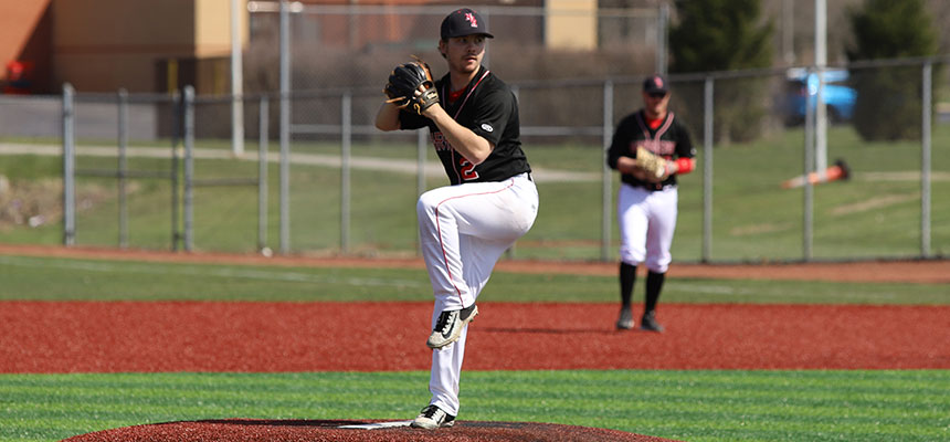 Hamilton pitcher on the mound with his leg in the air getting ready to throw the ball.