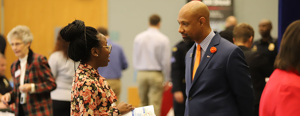A female student talking to an employer at the All Majors Career fair.