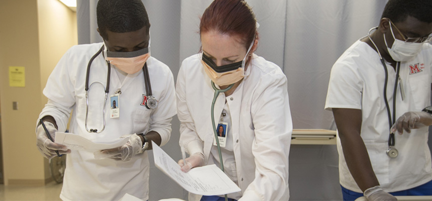 Nursing students looking at a piece of paper
