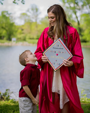 Amberly Larkin in her cap and gown look down at her godson Nathan.