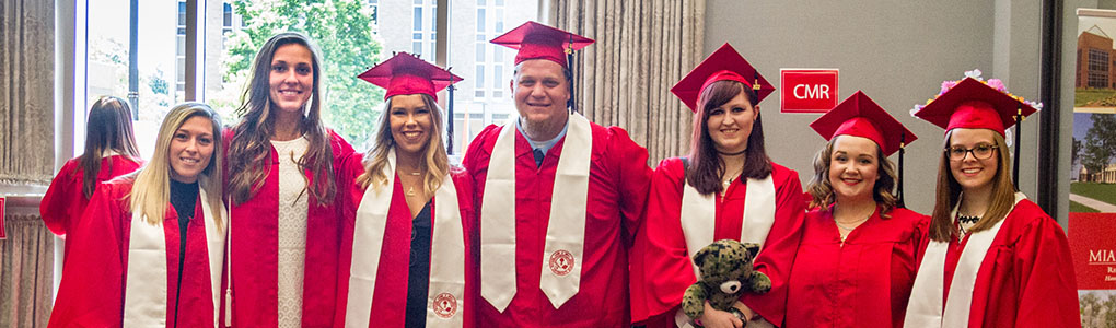 Students at commencement in their caps and gown.