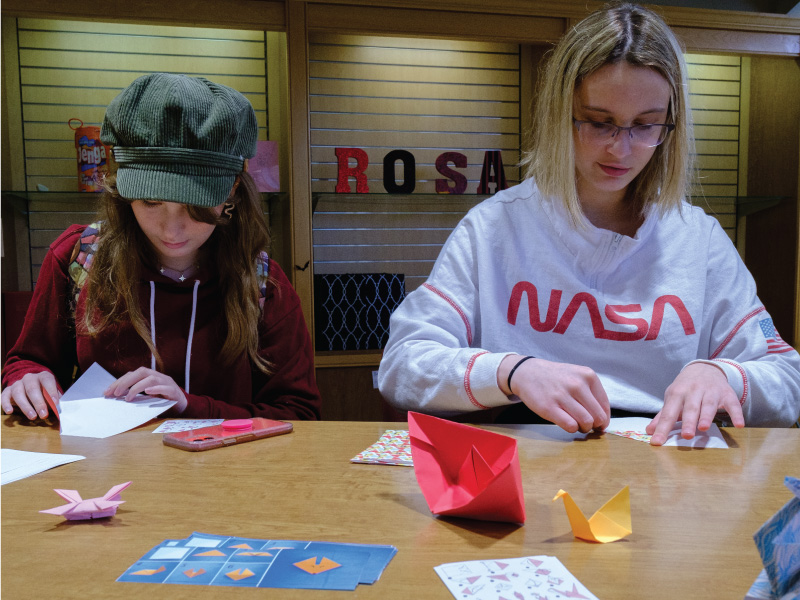 Students doing origami in the ROSA office. 