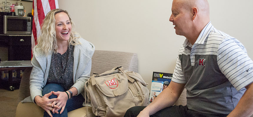 A student talking to the Veterans coordinator in the Veterans Center at Hamilton.