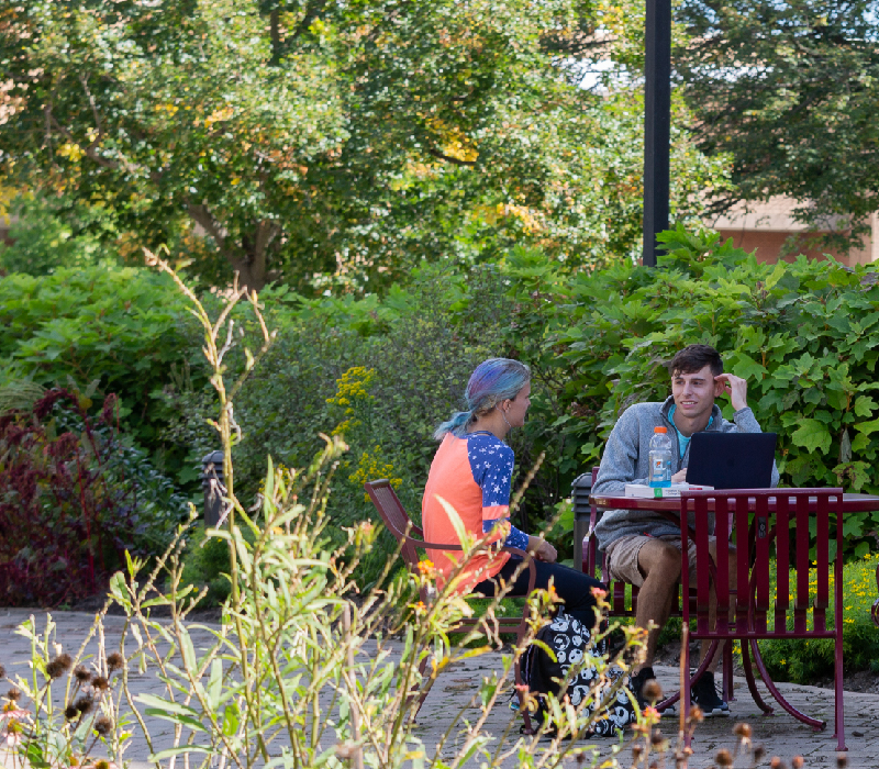 students sitting together outside