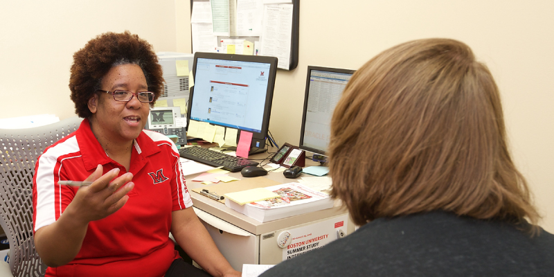A student meeting with an academic advisor to schedule classes.