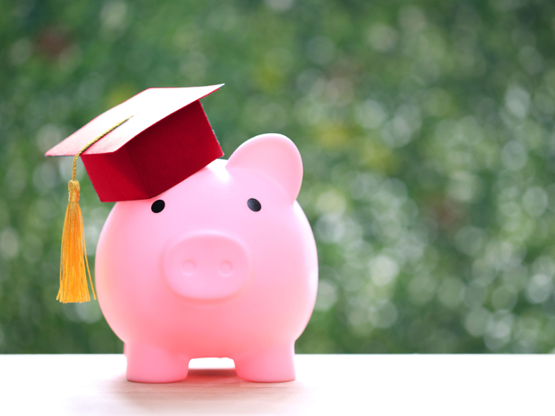 A piggy bank with a graduation cap