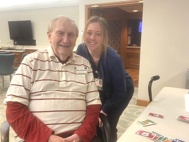 Maggie Schmidt playing UNO with Community First Solutions resident Mike Schuler