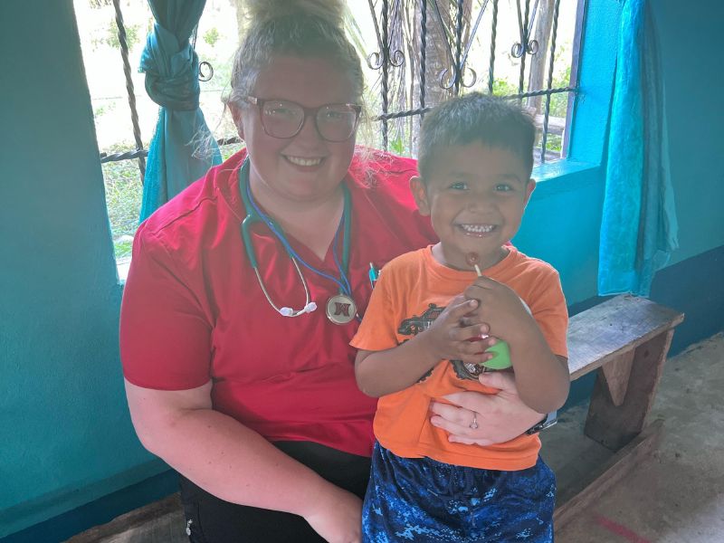 Kendall Robinson with a young patient while serving on a mission trip in Jamaica. 