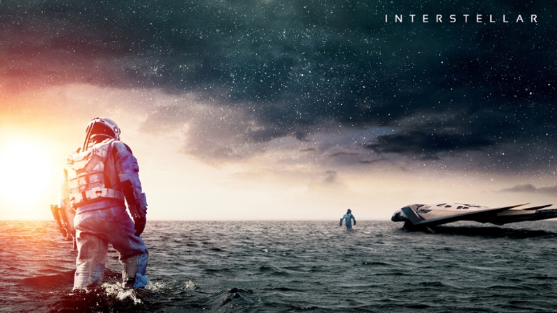 Two astronauts from the movie Interstellar walking away in a large ocean; a starry sky above them. Text reads Interstellar.