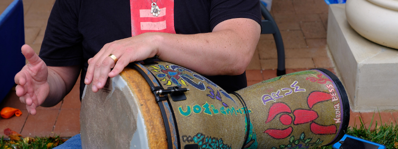 Miami student drumming in a park