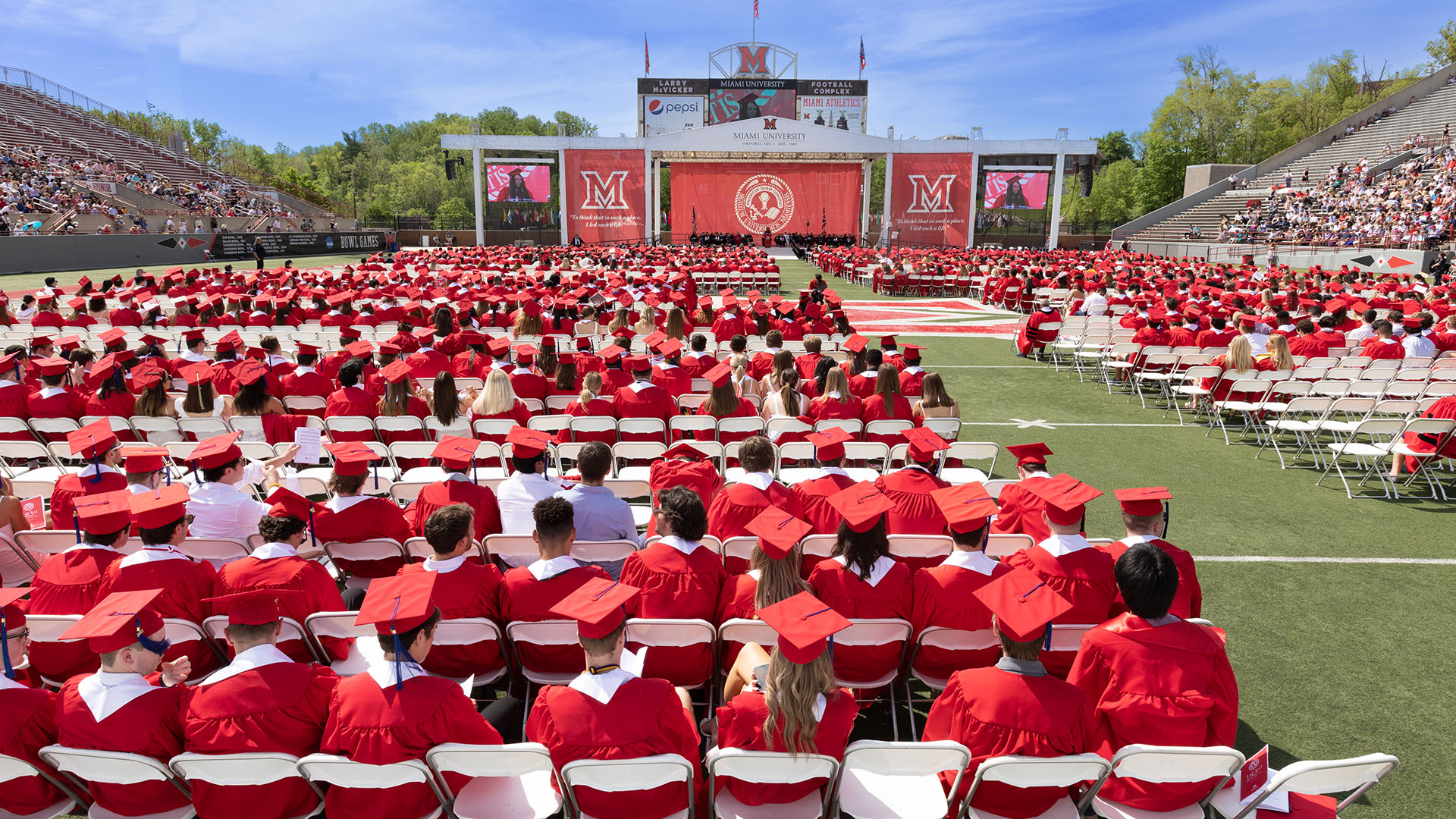 Miami students in red caps and gowns during the main university commencement ceremony
