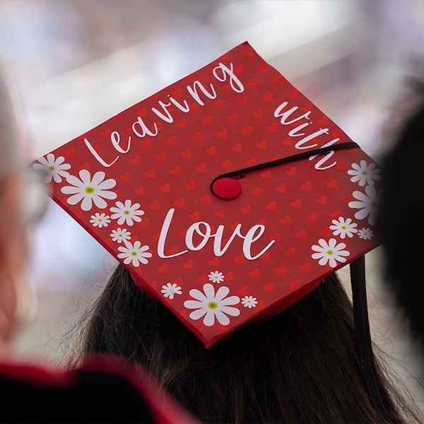 Graduation cap that says 'leaving with love'
