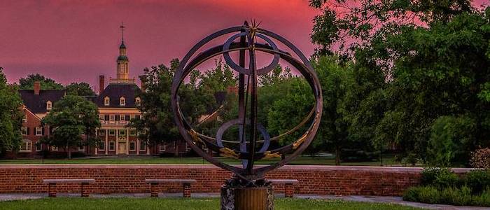 The Sundial in the summer afternoon with pink and purple hues in the sky from the setting sun.