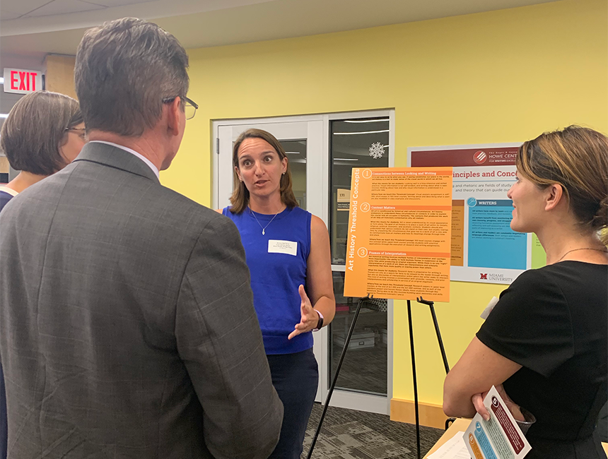 Art History Assistant Professor Annie Dell’Aria (center) talks with Provost and Executive Vice President for Academic Affairs Jason Osborne (left) and National Advisory Board Member Jennifer Grutsch McKinney (right) about their Disciplinary Writing Guide.