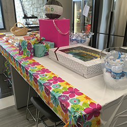 Table of retirement goodies, presents and cake.