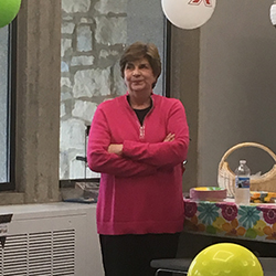 Mary Beth Dillon wearing a pink sweater and smiling.