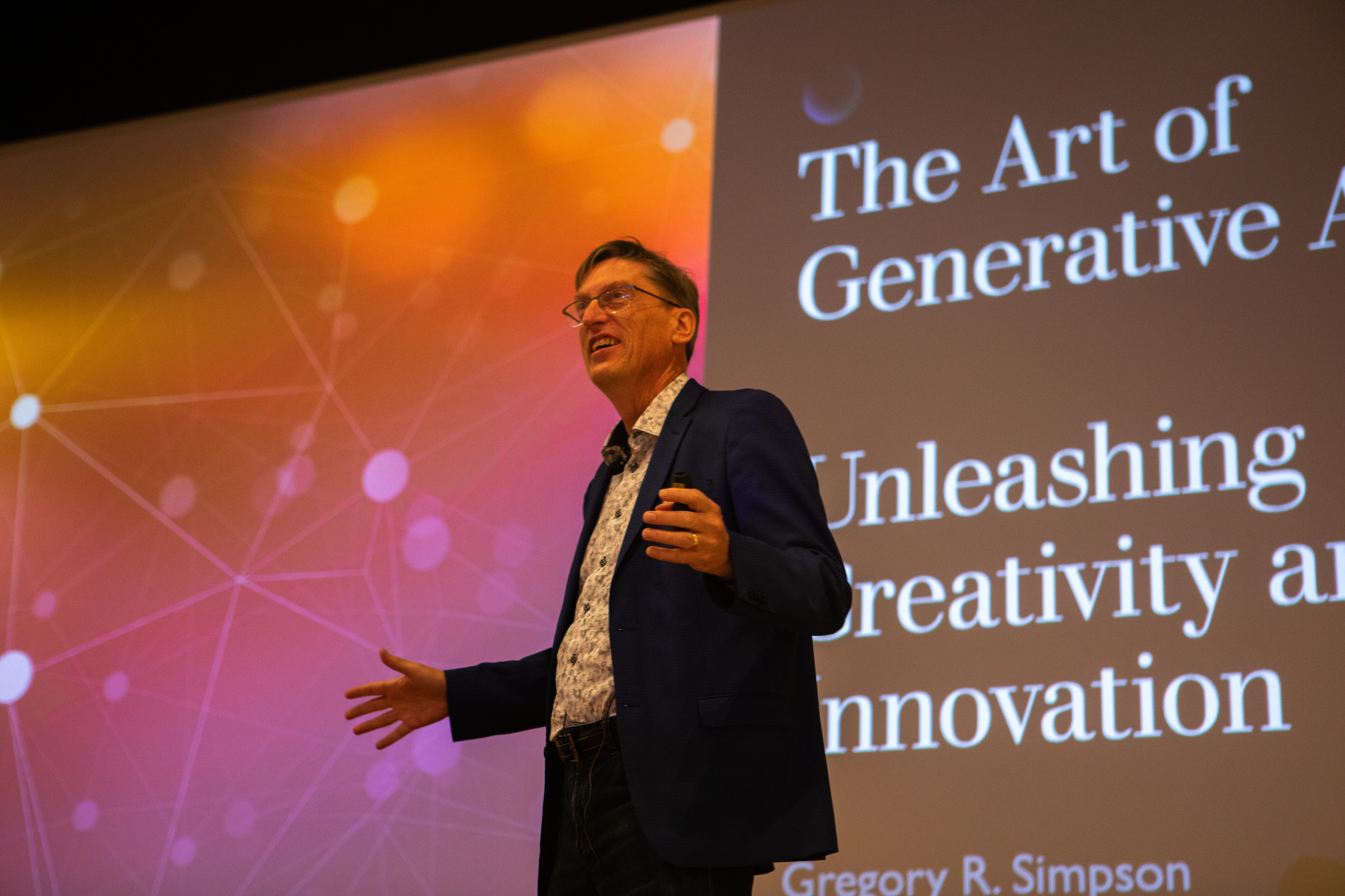 Greg Simpson talks to attendees at the AI symposium in the Wilks Theatre in the Armstrong Student Center