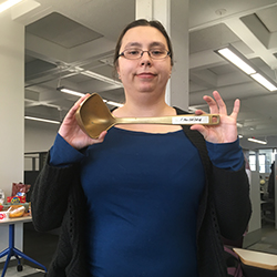 Emily Schmidt holding the golden ladle, the prize for winning the chili competition.