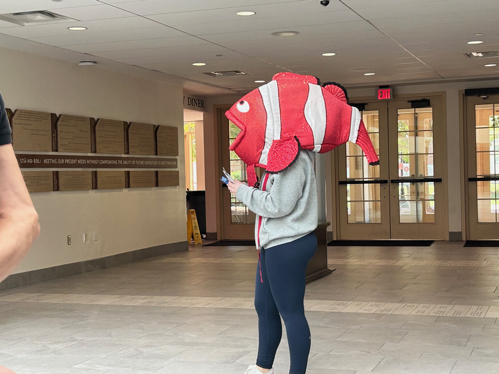 Student intern wearing a costume Fish Head at a cybersecurity awareness event