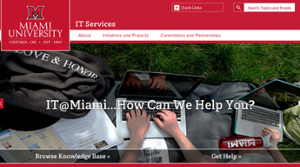 top section of the IT Services website homepage showing hands typing on a keyboard with the words IT at Miami how can we help you?